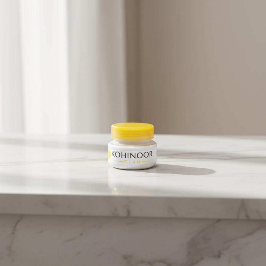 Jar of Kohglam on a marble surface with a neutral background